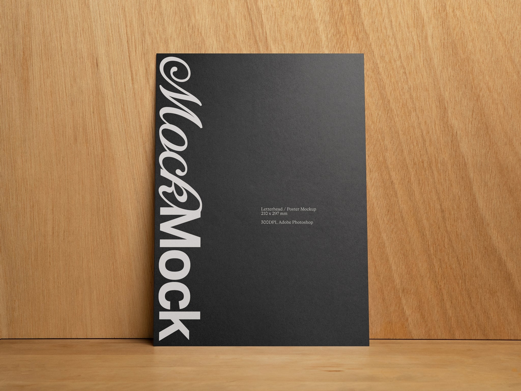 Black poster print mockup standing against a wooden background