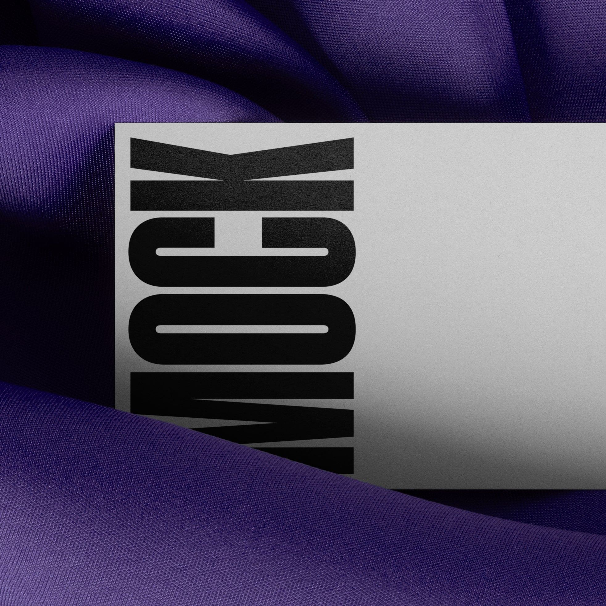 High-quality branding mockup featuring stationery print items, showing a business card on a purple background made of cloth fabric. Created by Sylvan Hillebrand.